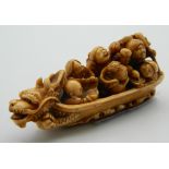 A 19th century carved ivory boat form okimono. 7 cm long.