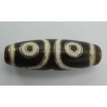 A gold inlaid dzi bead. 3.5 cm long.