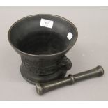 A patinated bronze pestle and mortar.