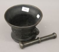 A patinated bronze pestle and mortar.