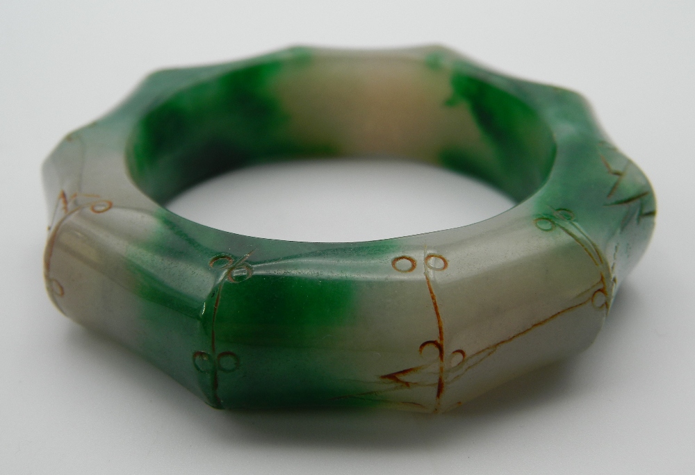 A jade faux bamboo carved bangle. 8 cm diameter.