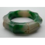 A jade faux bamboo carved bangle. 8 cm diameter.