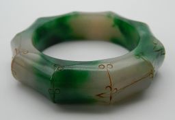 A jade faux bamboo carved bangle. 8 cm diameter.