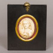 A 19th century carved ivory panel Of oval form, carved as the Virgin Mary,