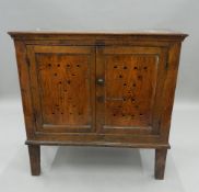 An 18th century oak food cupboard. 93.5 cm wide.