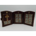 A folding leather cased Stations of the Cross. 11.5 cm high.