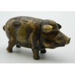 A brass vesta formed as a pig. 6 cm long.