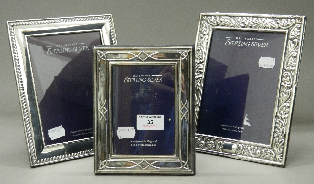 Three modern sterling silver photograph frames. The largest 17.5 cm x 22 cm.