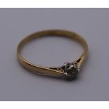 An 18 ct gold diamond solitaire ring. Ring Size R/S. 1.7 grammes total weight.