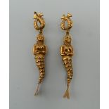 A pair of Continental 19 K gold earrings formed as articulated mermaids. Each 6.5 cm high. 8.