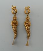 A pair of Continental 19 K gold earrings formed as articulated mermaids. Each 6.5 cm high. 8.