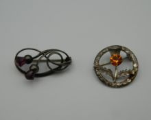 A Charles Horner thistle formed brooch, together with another. The former 3 cm high.