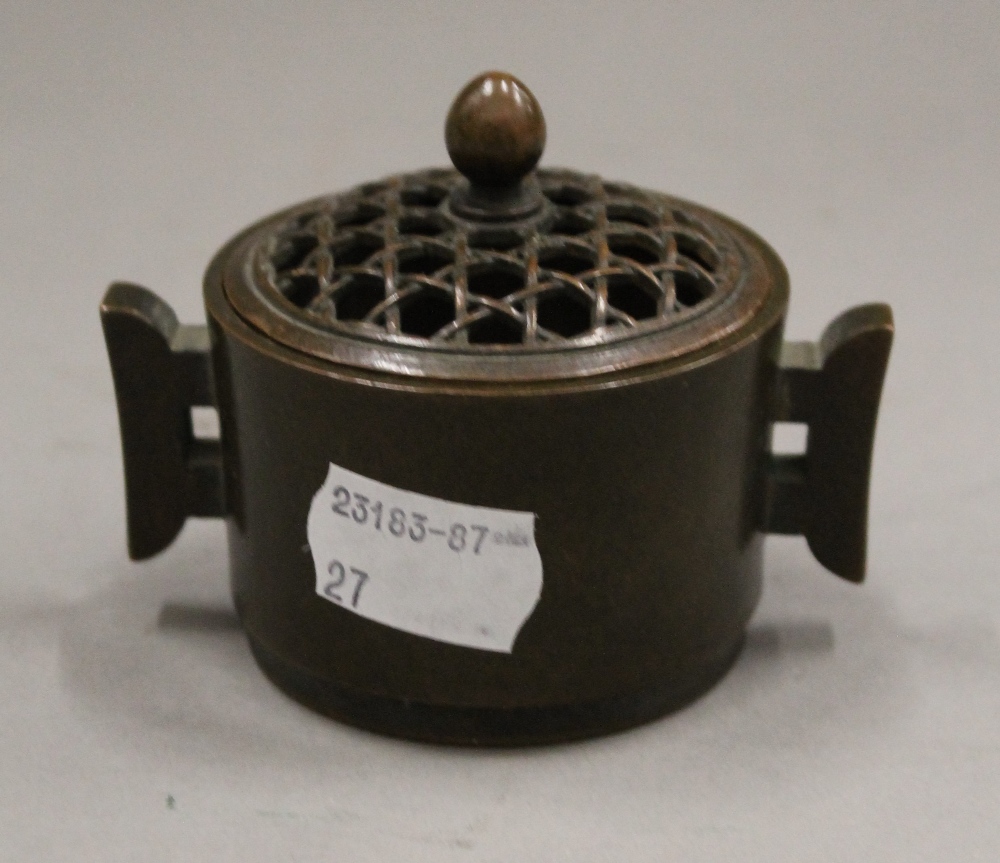 A Chinese pierced top lidded bronze censer. 6.5 cm high.