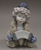 A Lladro bust of a clown playing an accordion. 17 cm high.