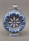 A Persian/Iznik pottery pierced moon flask. 25 cm high.