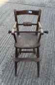 A Victorian elm seated child's highchair. 80 cm high.