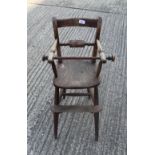 A Victorian elm seated child's highchair. 80 cm high.