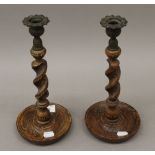 A pair of oak barley twist candlesticks. 29 cm high.