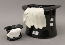 Two porcelain top hats. The largest 18 cm high.