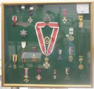 A framed collection of Masonic medals. 61.5 cm wide.