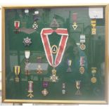 A framed collection of Masonic medals. 61.5 cm wide.