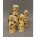 Four Royal Worcester blush ivory florally decorated ewers. The largest 26 cm high.