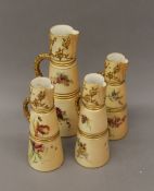 Four Royal Worcester blush ivory florally decorated ewers. The largest 26 cm high.