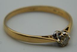 An 18 ct gold diamond solitaire ring. Ring Size M. 2.4 grammes total weight.