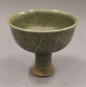 A Chinese celadon pottery stem cup. 11.5 cm high.