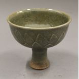 A Chinese celadon pottery stem cup. 11.5 cm high.
