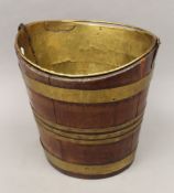 A 19th century brass bound oval wooden bucket. 35 cm high.