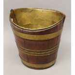 A 19th century brass bound oval wooden bucket. 35 cm high.