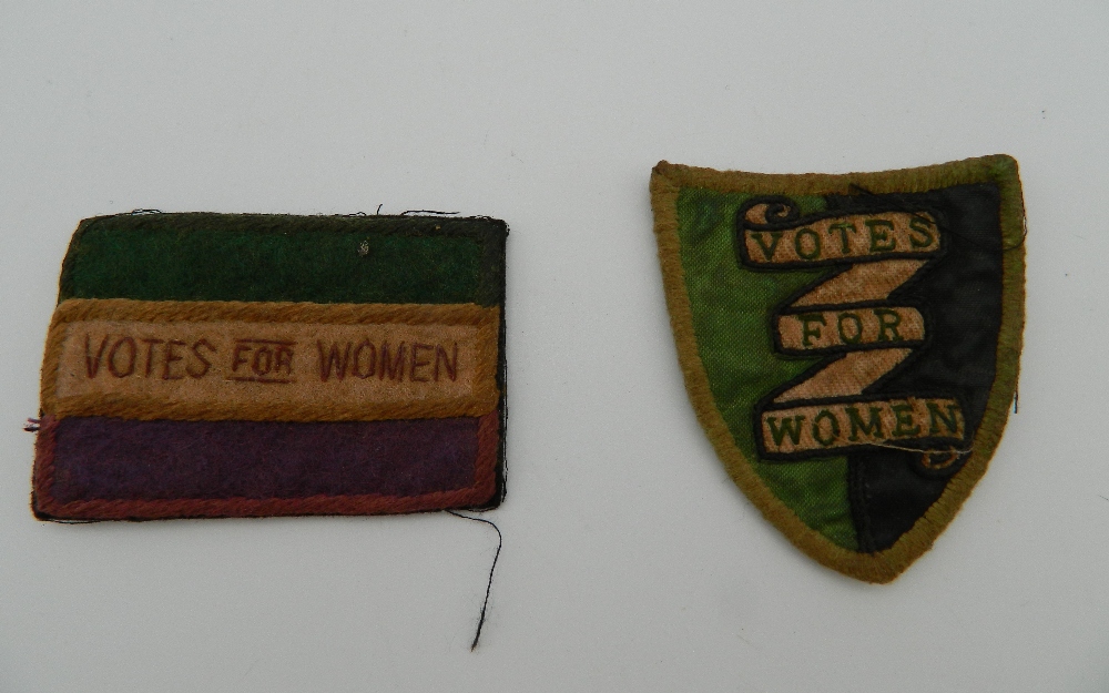 Two small Vote for Women suffragette type cloth patches, one shield shaped, the other rectangular.