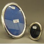 Two oval silver photograph frames. The largest 16.5 cm x 24 cm.