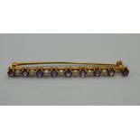 A 14 K gold, amethyst and seed pearl brooch. 5.5 cm long. 3.9 grammes total weight.