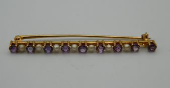 A 14 K gold, amethyst and seed pearl brooch. 5.5 cm long. 3.9 grammes total weight.