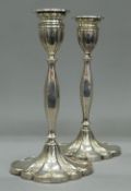 A pair of petal based silver candlesticks, hallmarked for Birmingham 1936. 30 cm high.