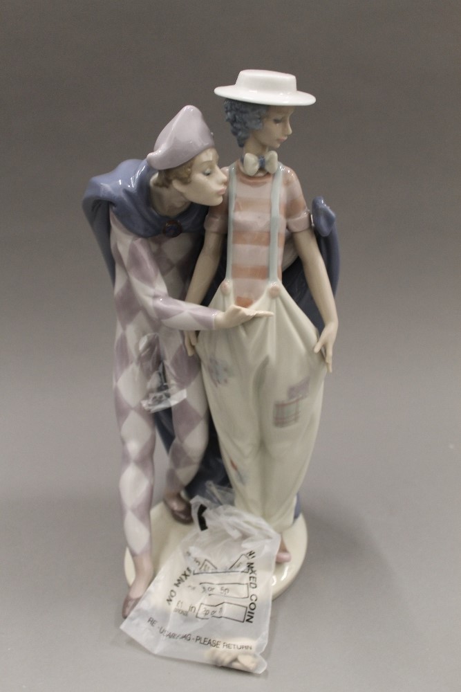 A large Lladro figural group. 31 cm high.