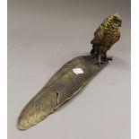 A bronze inkwell formed as an owl on a feather. 34 cm long.