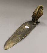 A bronze inkwell formed as an owl on a feather. 34 cm long.