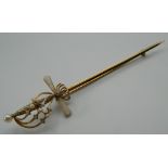 A 14 K gold and enamel sword brooch. 10 cm long. 5 grammes total weight.