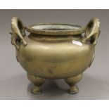 A Chinese dog-of-fo handle bronze censer. 26 cm wide.