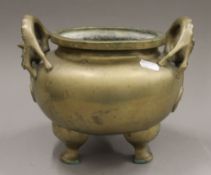 A Chinese dog-of-fo handle bronze censer. 26 cm wide.