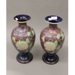 A pair of Royal Doulton stoneware vases. 35 cm high.