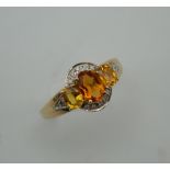 A 9 ct gold Art Deco style topaz, citrine and diamond ring. Ring Size N/O.