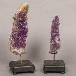 Two amethyst mineral specimens Each mounted on a later display stand.