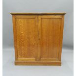 A Victorian oak two-door cupboard. 106.5 cm wide. The property of Germaine Greer.