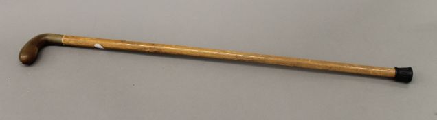 A Victorian Malacca cane with rhino horn handle. 81 cm long.