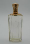 A gold topped scent bottle. 9 cm high.