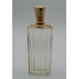 A gold topped scent bottle. 9 cm high.